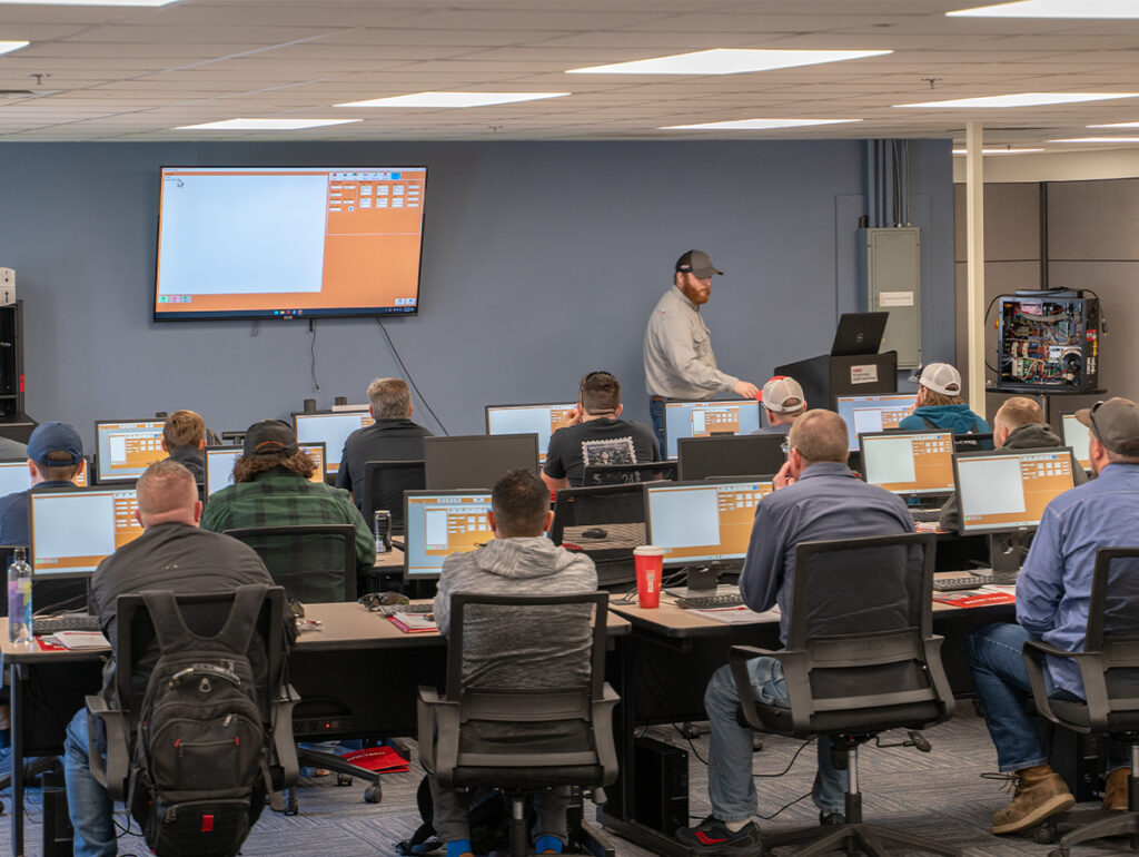 alt=Applications Engineering teaching the Bend-Tech software to a classroom full of students