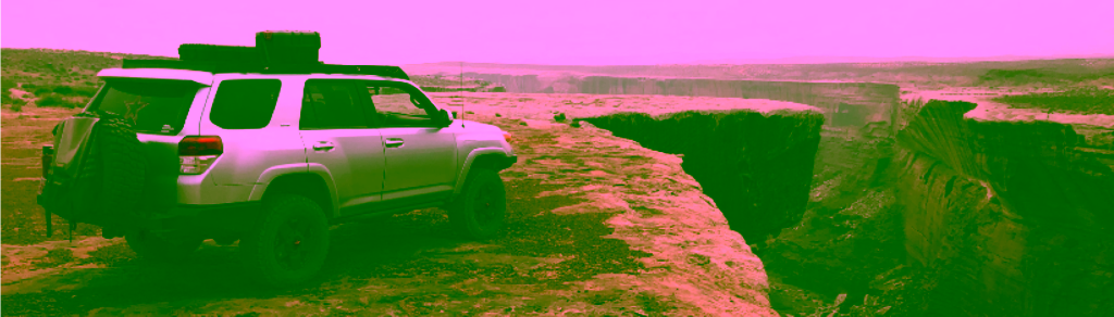 Offroad car overlooking canyon
